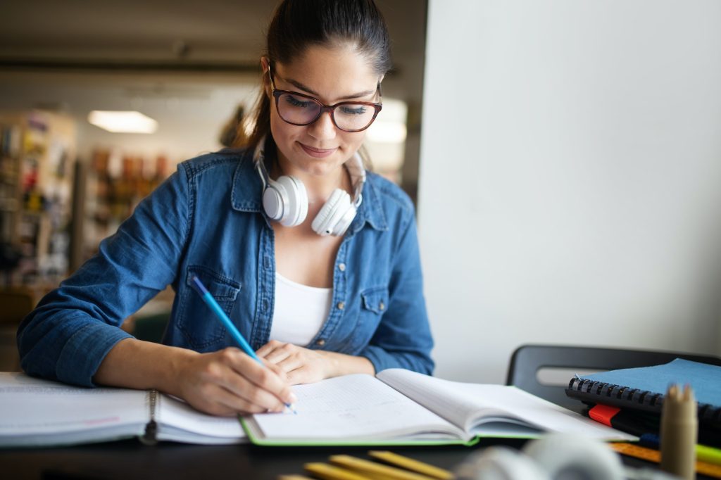 Beautiful student woman studying and learning at college
