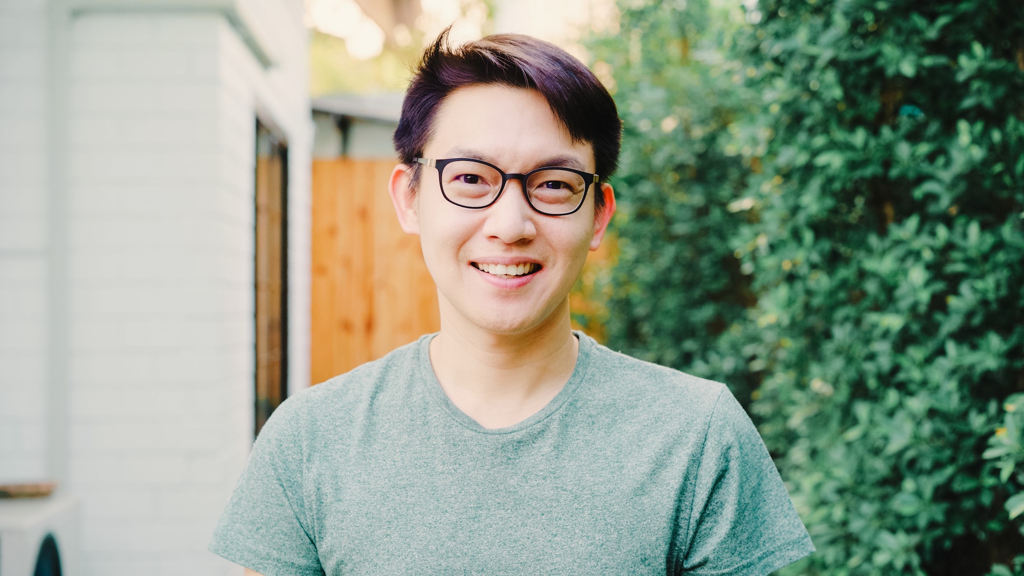 Portrait Asian Chinese man feeling happy smiling at house.