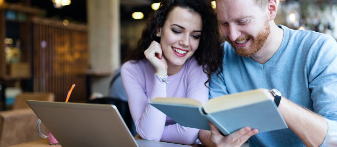 Attractive students learning together in coffee shop